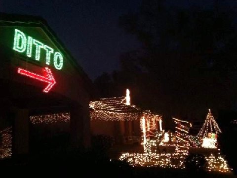 Neighbor puts up a HUGE lighted christmas sign that says DITTO with an arrow pointing to his next door neighbors decorated house