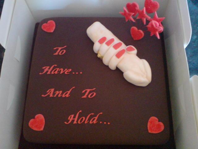 wedding cake says "to have and to hold..." includes woman's hand holding his male part